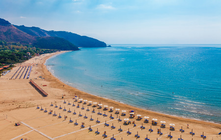 Beach and sea landscape with Sperlonga, Lazio, Italy. Scenic resort town village with nice sand beach and clear blue water in picturesque bay. Famous tourist destination Riviera de Ulisseの写真素材