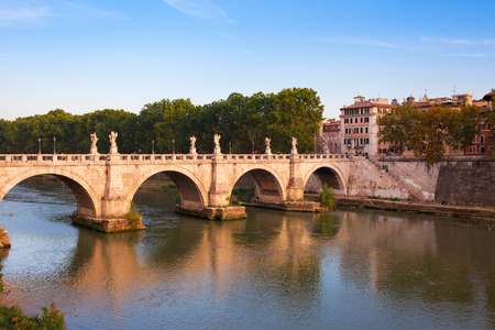Panorama cityscape from the ancient embankment Tiber in Roma at sunset. Near of bridge and castle of Angels. Saint Angelo castle and bridge is famous tourist destination in Italyの写真素材