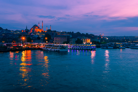 Night view of Istanbul. Panorama cityscape of famous tourist destination Golden Horn bay part of Bosphorus strait. Travel illuminated landscape Bosporus, Turkey, Europe and Asia.の写真素材