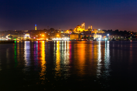 Night view of Istanbul. Panorama cityscape of famous tourist destination Golden Horn bay part of Bosphorus strait. Travel illuminated landscape Bosporus, Turkey, Europe and Asia.の写真素材