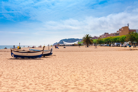 Beach at seaside in Calella in Catalonia, Spain near Barcelona. Scenic old town with sand beach and clear blue water. Famous tourist destination in Costa Brava, perfect place for holiday and vacationの写真素材