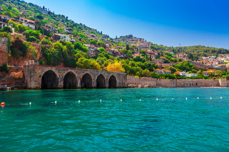 Landscape of ancient shipyard near of Kizil Kule tower in Alanya peninsula, Antalya district, Turkey, Asia. Famous tourist destination with high mountains. Part of ancient old Castle. Summer dayの写真素材
