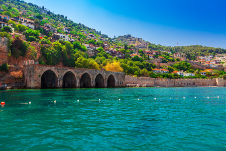 Landscape of ancient shipyard near of Kizil Kule tower in Alanya peninsula, Antalya district, Turkey, Asia. Famous tourist destination with high mountains. Part of ancient old Castle. Summer dayの素材 [FY310123076321]