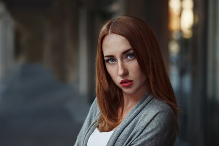 Beautiful redhair young woman in casual closes in urban background. Fashion Photoの写真素材
