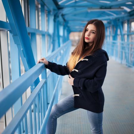 Outdoor fashion lifestyle portrait of pretty young girl, wearing in hipster swag grunge style urban background. Tomboy city conceptの写真素材