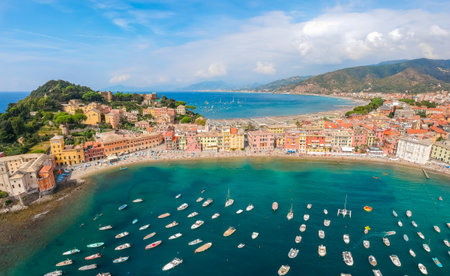 Sea aerial landscape in Sestri Levante, Liguria, Italy. Scenic fishing village with traditional houses and clear blue water. Summer vacation rich resort with picturesque harbor and nice sand beachの写真素材