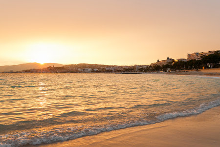 Sunset in Cannes, Cote d'Azur, France, South Europe. Nice city and luxury resort of French riviera. Famous tourist destination with nice beach and Promenade de la Croisette on Mediterranean seaの写真素材