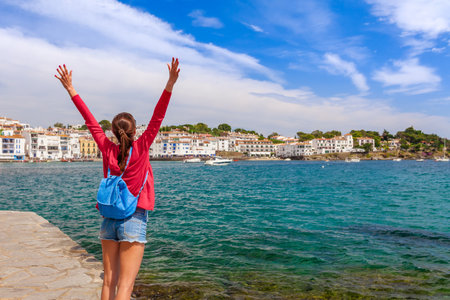 Tourist woman in Cadaques, Catalonia, Spain near of Barcelona. Scenic old town with nice beach and...