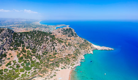 Aerial birds eye view drone photo Tsambika beach near Kolympia on Rhodes island, Dodecanese, Greece. Sunny panorama with sand beach and clear blue water. Famous tourist destination in South Europeの写真素材