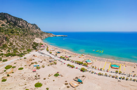 Aerial birds eye view drone photo Tsambika beach near Kolympia on Rhodes island, Dodecanese, Greece. Sunny panorama with sand beach and clear blue water. Famous tourist destination in South Europeの写真素材