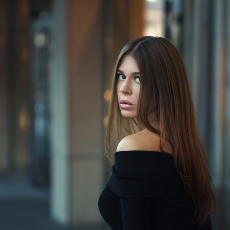 Portrait of a beautiful young brunette woman with long hair in the cityの写真素材