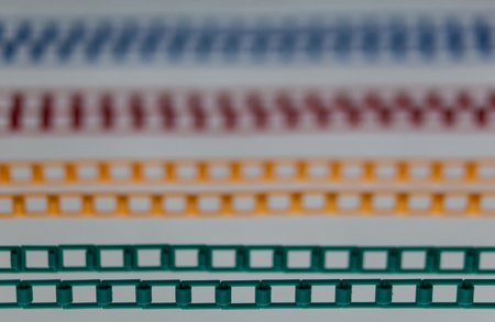 Close-up of a row of colored metal bars on a white backgroundの写真素材