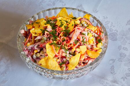 Chips, pepper and green peas salad costs on a tableの写真素材