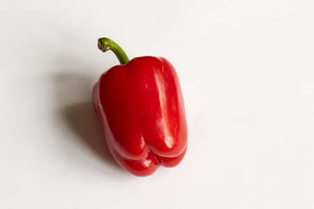Red paprika is located on a white background with a shadow.の写真素材