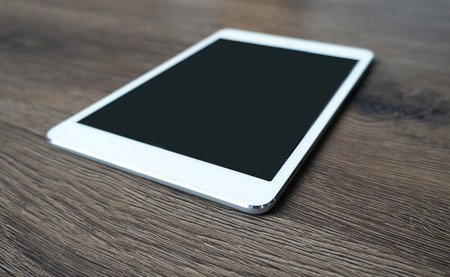 Tablet on the Wooden Texture Mock Upの写真素材