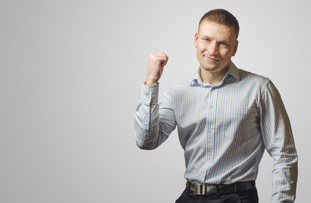 Young business man showing his hands mark "yes". Isolated on white background.の写真素材