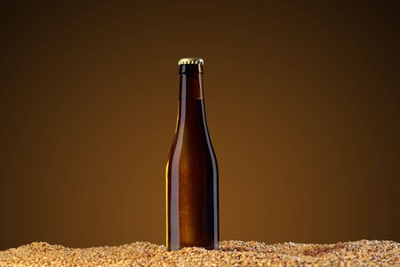 Drink mockup series. Brown beer bottle with reflections that stands on corns of wheat on a umber studio background. Template ready to use on your showcase.の写真素材