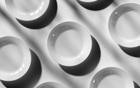 White plates template 3D rendering, dishes for presentation with realistic shadows on the background, top view. Unfolded round crockery for design.Layout of ceramic, porcelain crockery for advertisingの写真素材