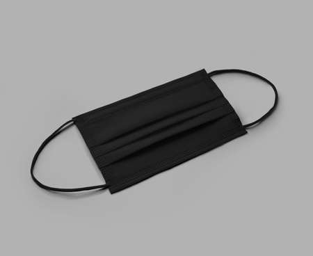 Mockup of a black surgical mask with ear loops, with shadows, with space for design, print, pattern. Uniform for branding, isolated on background. Template of folded new respirator,protection accessoryの写真素材