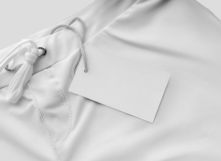 Mockup of white men's trunks for swimming, boxers close-up with a tag, label, for branding, design, pattern, advertising. Summer swimwear template, subject isolated on background.の写真素材