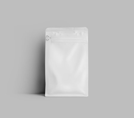 Mockup of a white doy pack for coffee beans, standing near the wall, the package is isolated on the background. Tea pouch template, stabilo pack gusset, for design, pattern, branding.の写真素材