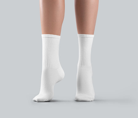Mockup of white long tiptoe socks front view, high gaiters on women legs isolated on background. Fashion casual footwear template, pair apparel on feet for design, print, pattern, advertisingの写真素材