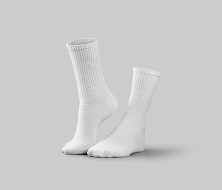 Mockup of white long socks 3d rendering, side view, one leg on tiptoes, isolated on a background with shadows. Stylish gaiters template, for design, print, pattern, branding. Pair of clothes for footの写真素材