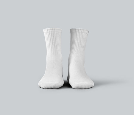Mockup of white medium socks 3d rendering, gaiters with place for design, print, pattern, advertising, front view. Template of clothes for legs, isolated on background. A pair of sportswearの写真素材
