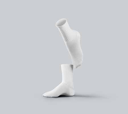 Template of white medium socks 3d rendering, one foot stretched, gaiters with space for design, pattern, advertising. Mockup of a pair of legwear, isolated on background, side view.の写真素材