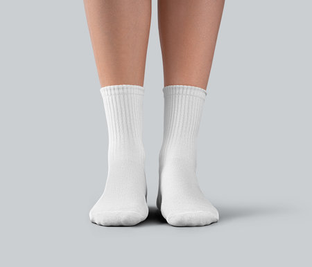 Mockup of white medium socks on a female foot, isolated on background, front view. Template of fashion gaiters with elastic band, for design, print, branding. Pair of clothes on foot for advertisingの写真素材