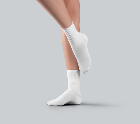 Mockup of white medium socks on women's stretched toes, for design, advertising, side view. Template of stylish women's gaiters with elastic average band on legs, isolated on background.の写真素材