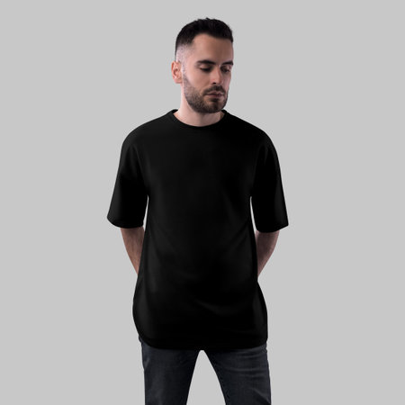 Mockup of black oversized t-shirt on bearded guy, front view, isolated on background. Men's round neck shirt template for design, print, pattern, branding. Product photography for advertisingの写真素材