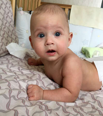 Beautiful baby boy with child face posing photographer for color photo. Cadre consisting of baby boy...
