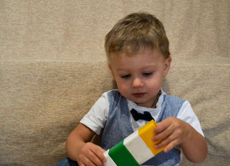 Beautiful baby boy with child face posing photographer for color photo. Cadre consisting of baby boy...