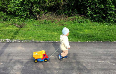 Beautiful baby boy with child face posing photographer for color photo. Cadre consisting of baby boy in child image, caucasian expression face. Healthy baby boy in child face relaxing for good shot.の写真素材