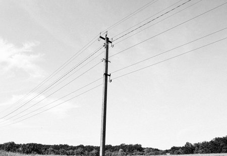 Power electric pole with line wire on colored background close up, photography consisting of power electric pole with line wire under sky, line wire in power electric pole for residential buildingsの写真素材
