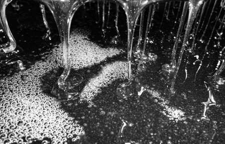 Drop of bee honey drip from hexagonal honeycombs filled with liquid nectar, honeycombs summer composition consisting of drop natural honey, drip on wax frame bee, drop of bee honey drip in honeycombsの写真素材