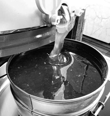 Drop of bee honey drip from hexagonal honeycombs filled with liquid nectar, honeycombs summer composition consisting of drop natural honey, drip on wax frame bee, drop of bee honey drip in honeycombsの写真素材