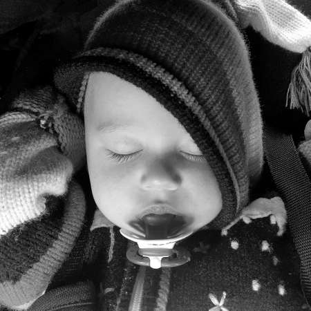 Sleeping baby boy with child pacifier posing photographer for color photo, cadre consisting of...