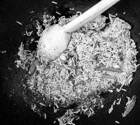 Photography to theme beautiful tasty rice grilled pilaf in pot ready for eating, photo consisting of rice grilled pilaf on pot with hot flames, rice grilled pilaf at pot from slice small vegetablesの写真素材