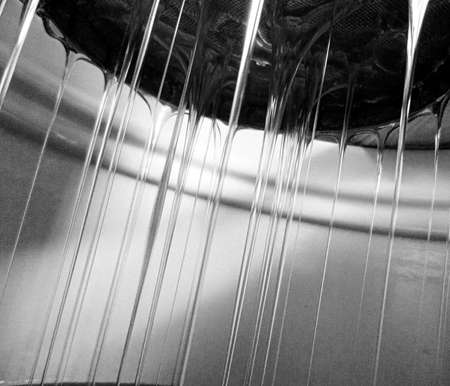 Drop of bee honey drip from hexagonal honeycombs filled with liquid nectar, honeycombs summer composition consisting of drop natural honey, drip on wax frame bee, drop of bee honey drip in honeycombsの写真素材