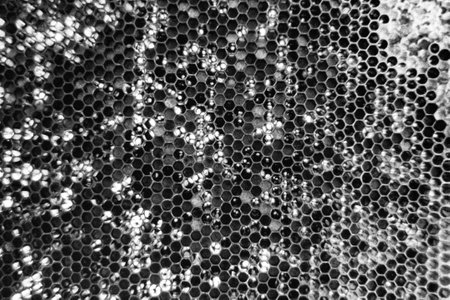 Drop of bee honey drip from hexagonal honeycombs filled with golden nectar, honeycombs summer...