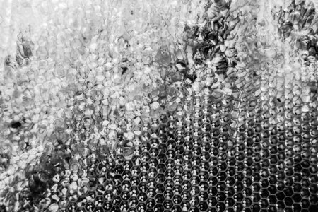 Drop of bee honey drip from hexagonal honeycombs filled with golden nectar, honeycombs summer...
