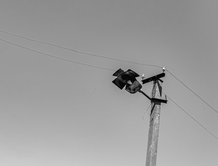 Power electric pole with line wire on light background close up, photography consisting of power...