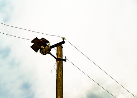 Power electric pole with line wire on colored background close up, photography consisting of power electric pole with line wire under sky, line wire in power electric pole for residential buildingsの写真素材