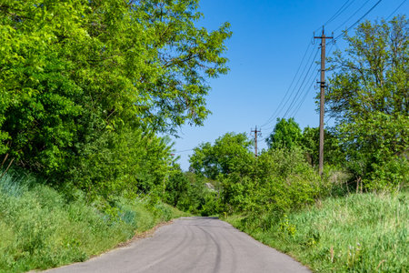 Beautiful empty asphalt road in countryside on colored background, photography consisting of new...