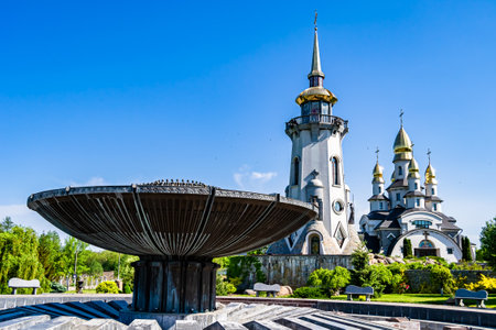 Christian church cross in high steeple tower for prayer, photography consisting of beautiful church with cross on steeple tower to sincere prayer, cross steeple tower is church over clear skyの写真素材