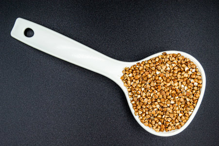 Beautiful organic dry buckwheat grains consisting of raw natural product. Dry buckwheat grains this is tasty food ingredient of porridge. Edible and healthy of dry hulled buckwheat grains from natureの写真素材