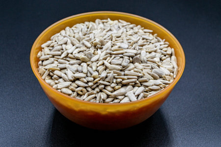 Many delicious summer sunflower seeds on grocery market counter, tasty organic food consisting of fresh raw sunflower seeds close up, beautiful texture ripe of natural sunflower seeds on backgroundの写真素材
