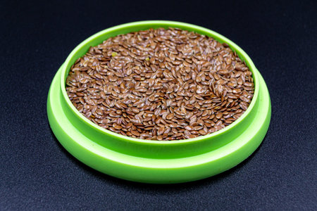 Many delicious summer flax seeds, tasty organic food consisting of fresh raw flax seeds close up,...